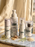 Spino skincare complete set products on a marble surface with a neutral background